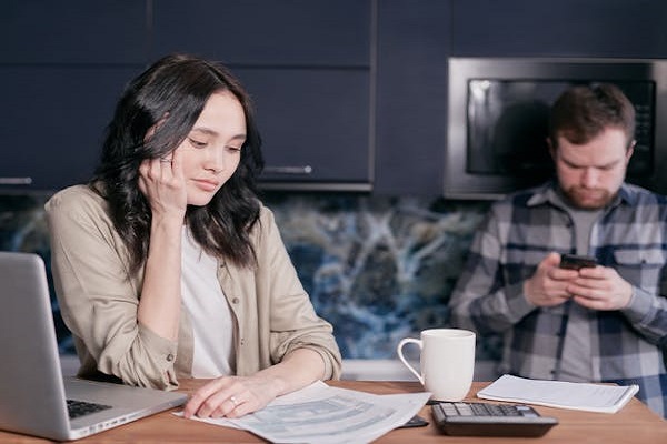 Two unhappy applicants sitting together, looking frustrated while considering urgent loans for bad credit options.